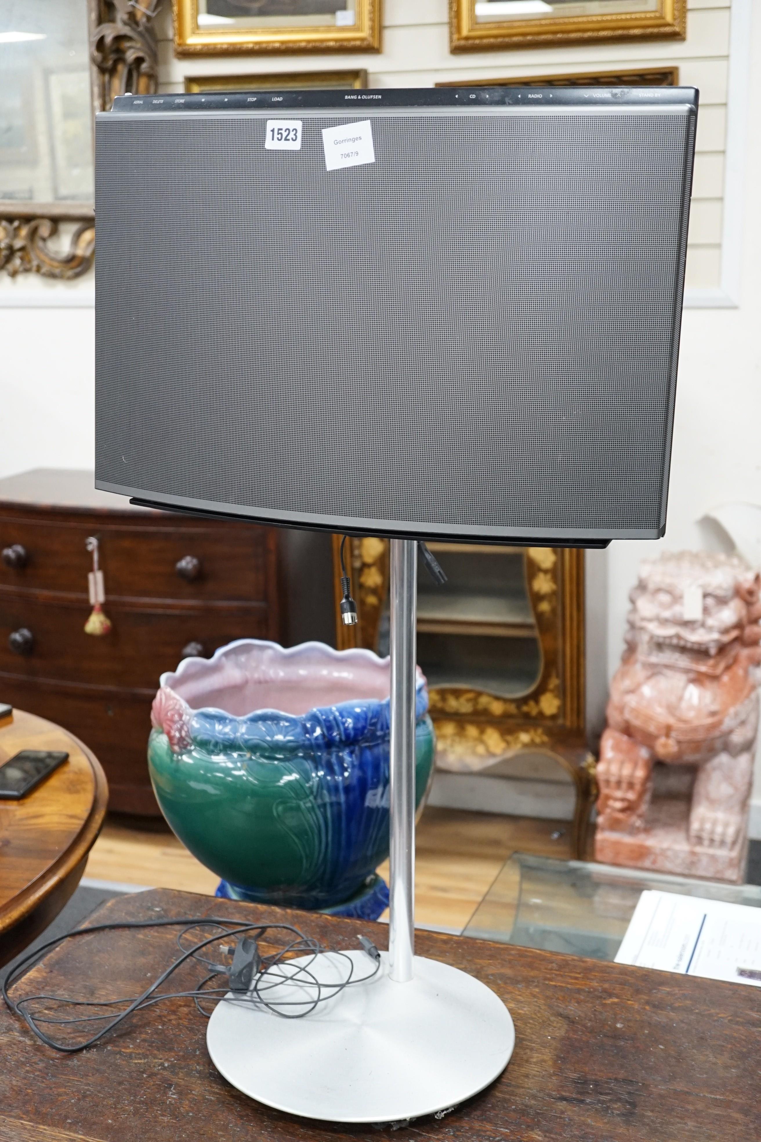 A Bang & Olufsen convex music centre on raised stand, 86 cms high